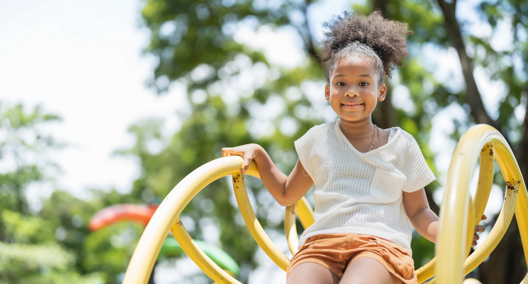 Young girl smiling on playground in Brentwood, TN.
