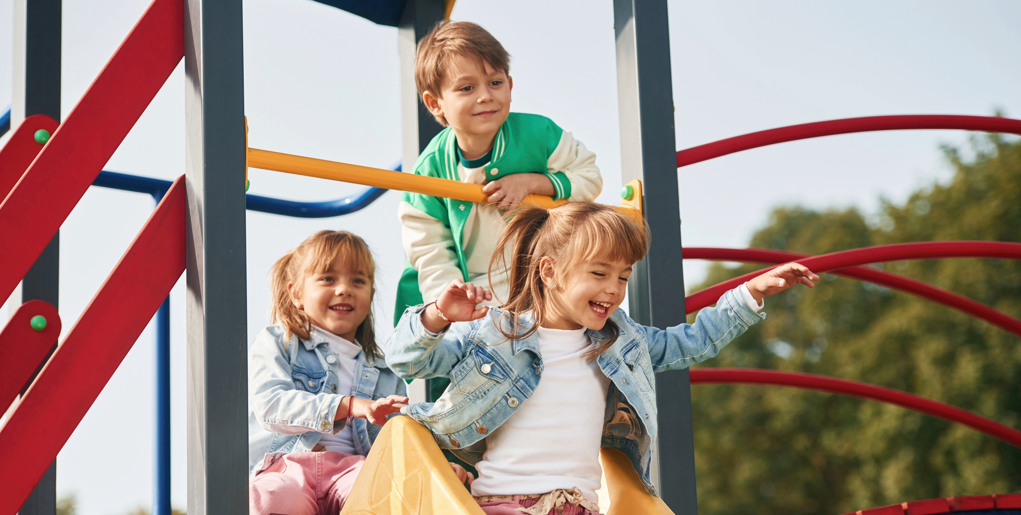 Three kids playing together on a playground in Franklin, Tennessee.