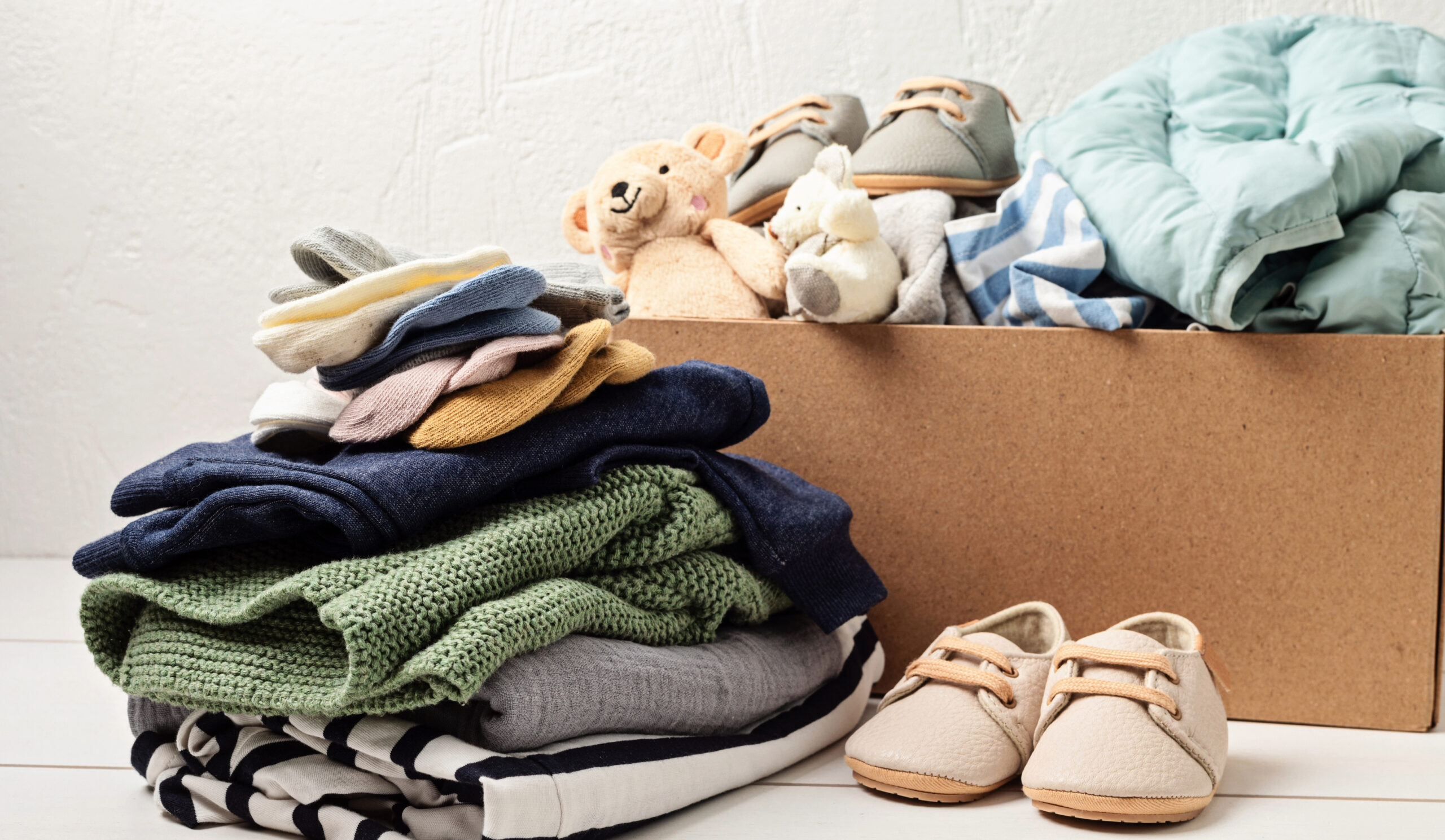 Baby and child clothes and toys in a box to donate in Franklin and Williamson County, Tennessee.