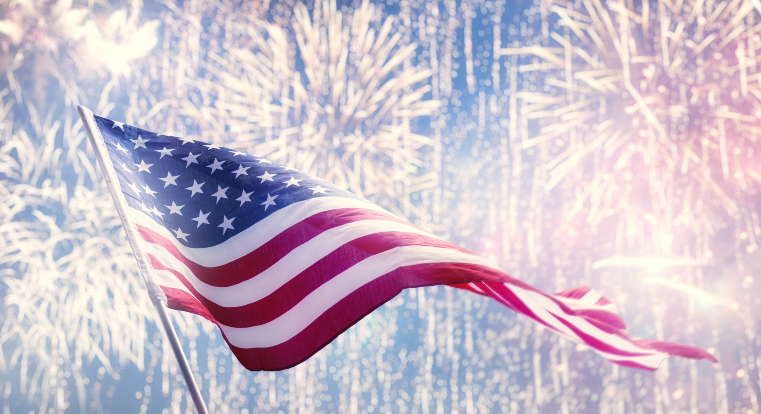 American Flag with fireworks show in Franklin, Tennessee, in the background.