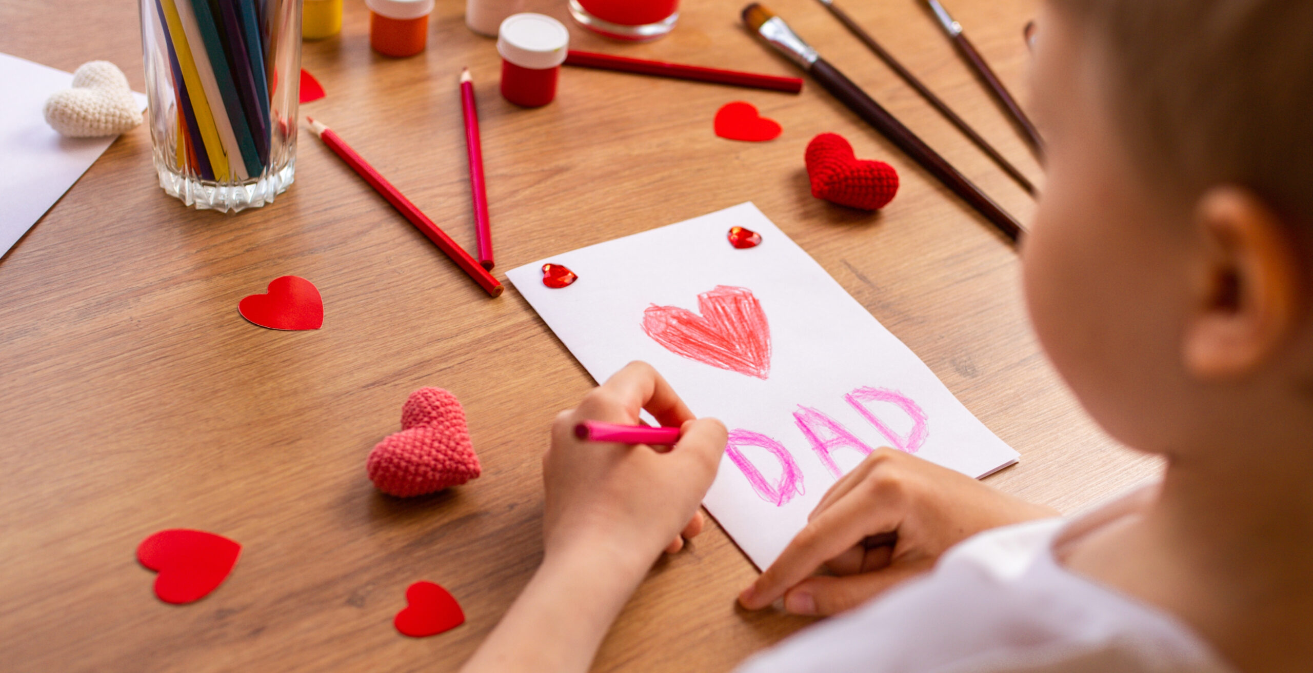 Toddler boy draws father's day card