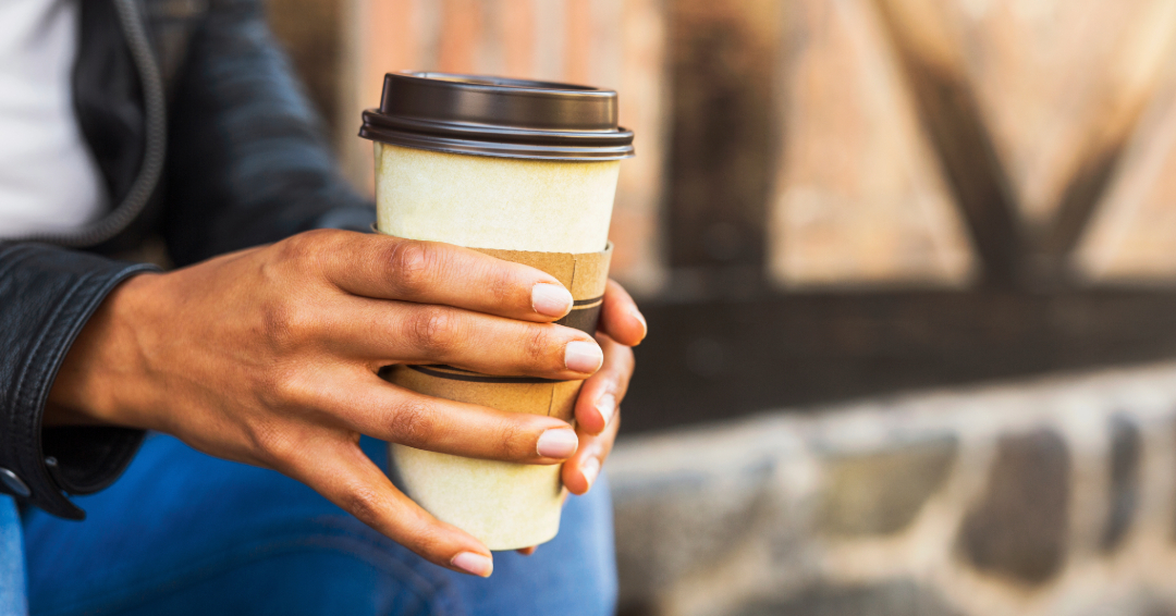Woman's hands holding a coffee to go. 
