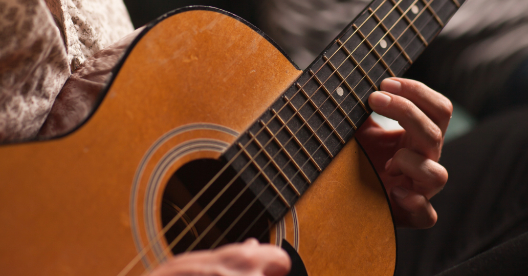 Man playing a guitar.