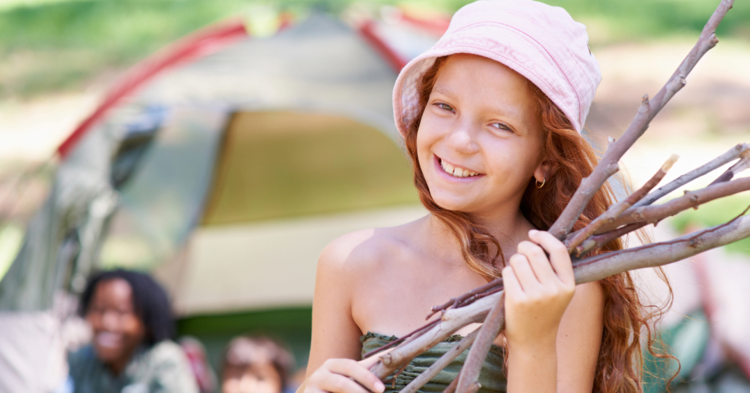 Girl at an outdoor summer camp in Franklin, TN, with firewood kindling.