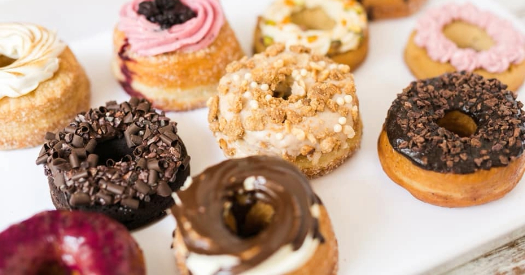 A row of donuts from Five Daughters Bakery in Nashville, Tennessee, in assorted flavors. 