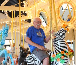 Ken Means on the Carousel of Dreams in Franklin, by Ken Means.