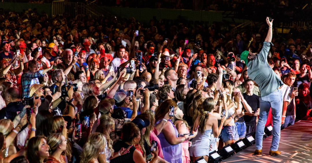 CMA Fest in Nashville, TN., a live performance on stage and a large crowd enjoying singing and live music.