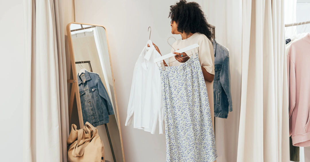 A woman trying on clothing in a dressing room: Discount shopping in Williamson County, Tennessee. 