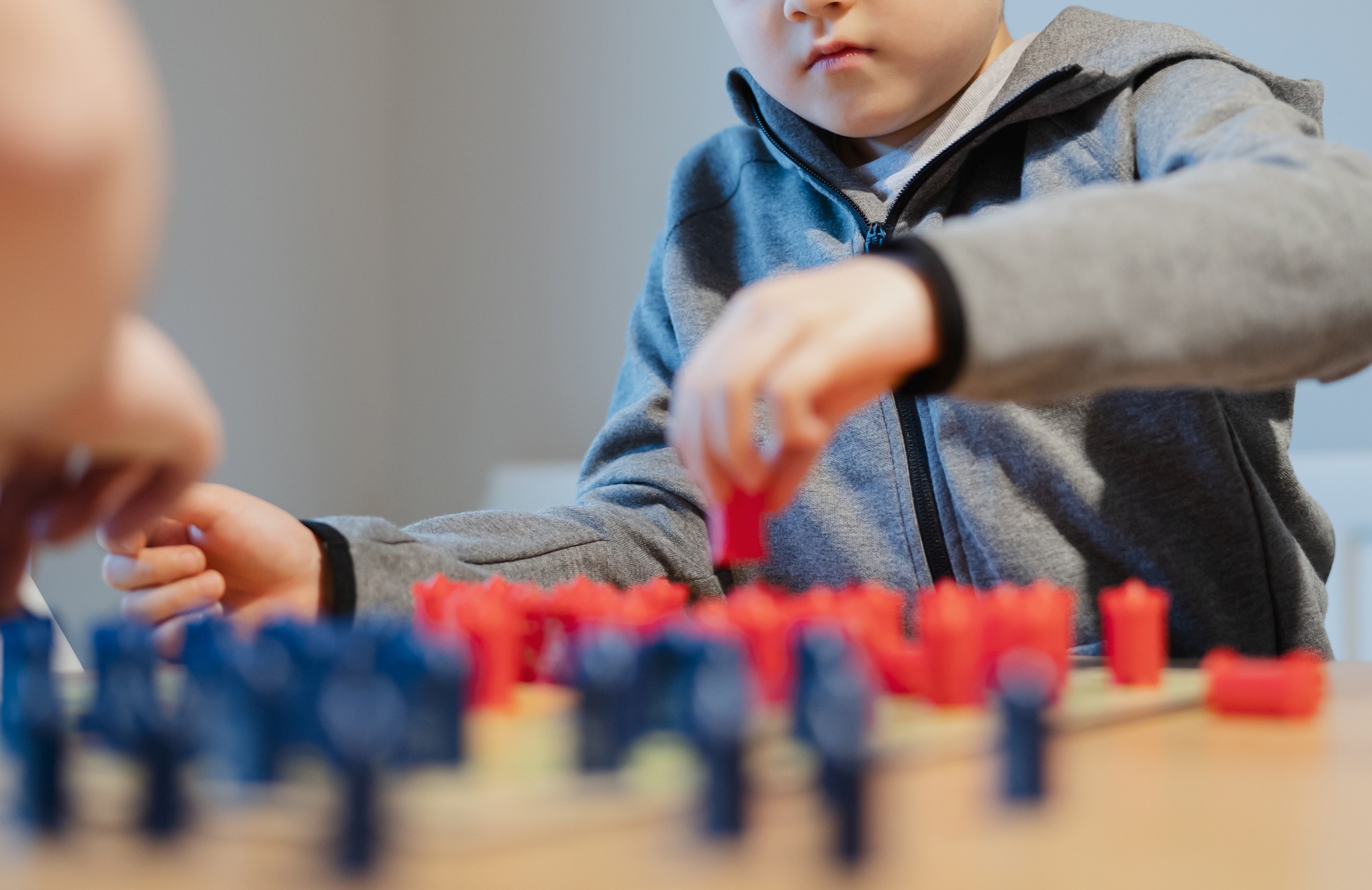A kid plays a strategy board game, representing recreation for all abilities in Franklin and Williamson County, Tennessee.