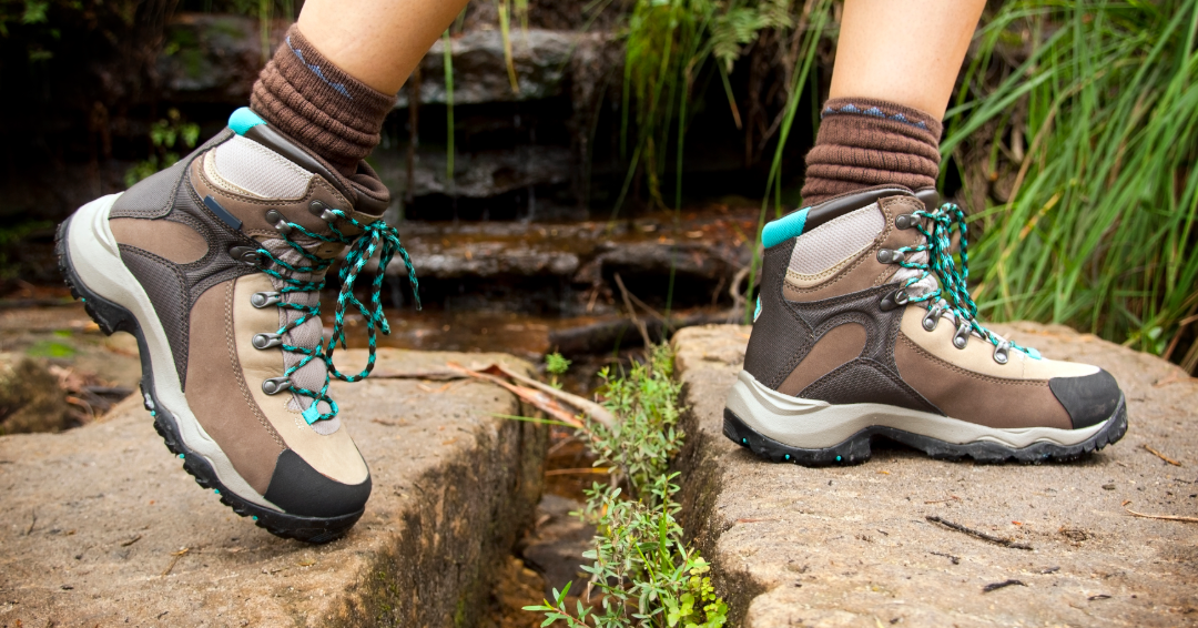 A woman in hiking boots crosses a stream: Outdoor hobbies in Williamson County, Tennessee. 