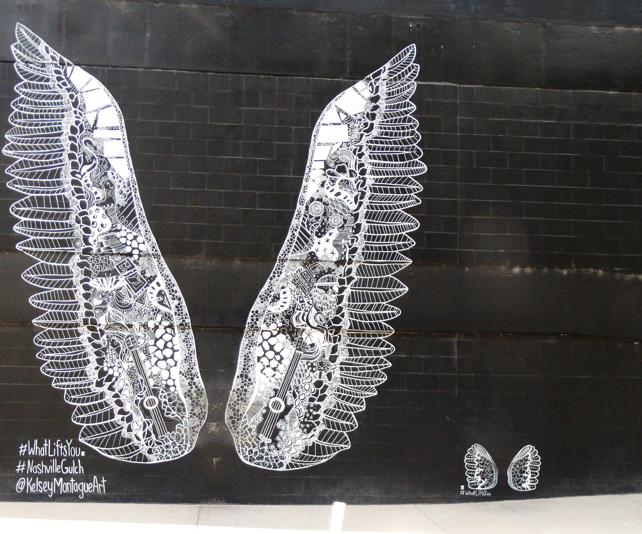 A mural In The Gulch in Nashville, Tennessee called "WhatLiftsYou," a popular photo spot among tourists is a great photo worthy spot with friends and family!