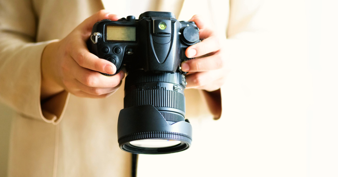 A woman holds a professional camera, photographing an engagement in Williamson County, Tennessee. 