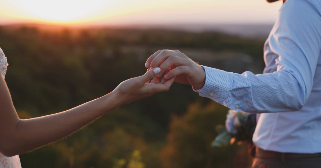 A couple holds hands at sunset, symbolizing perfect places to get engaged in Williamson County, Tennessee. 