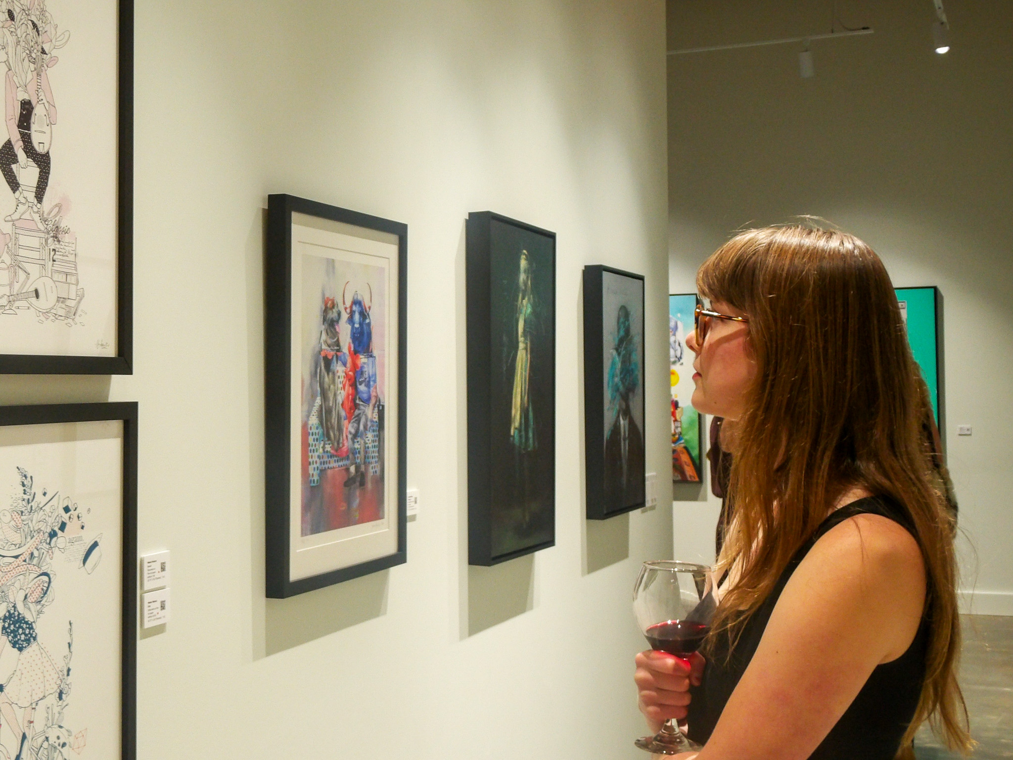 A guest of CASS Contemporary looks at art during the grand opening, CLTRL CNTXT Exhibit in Nashville's Wedgewood-Houston.