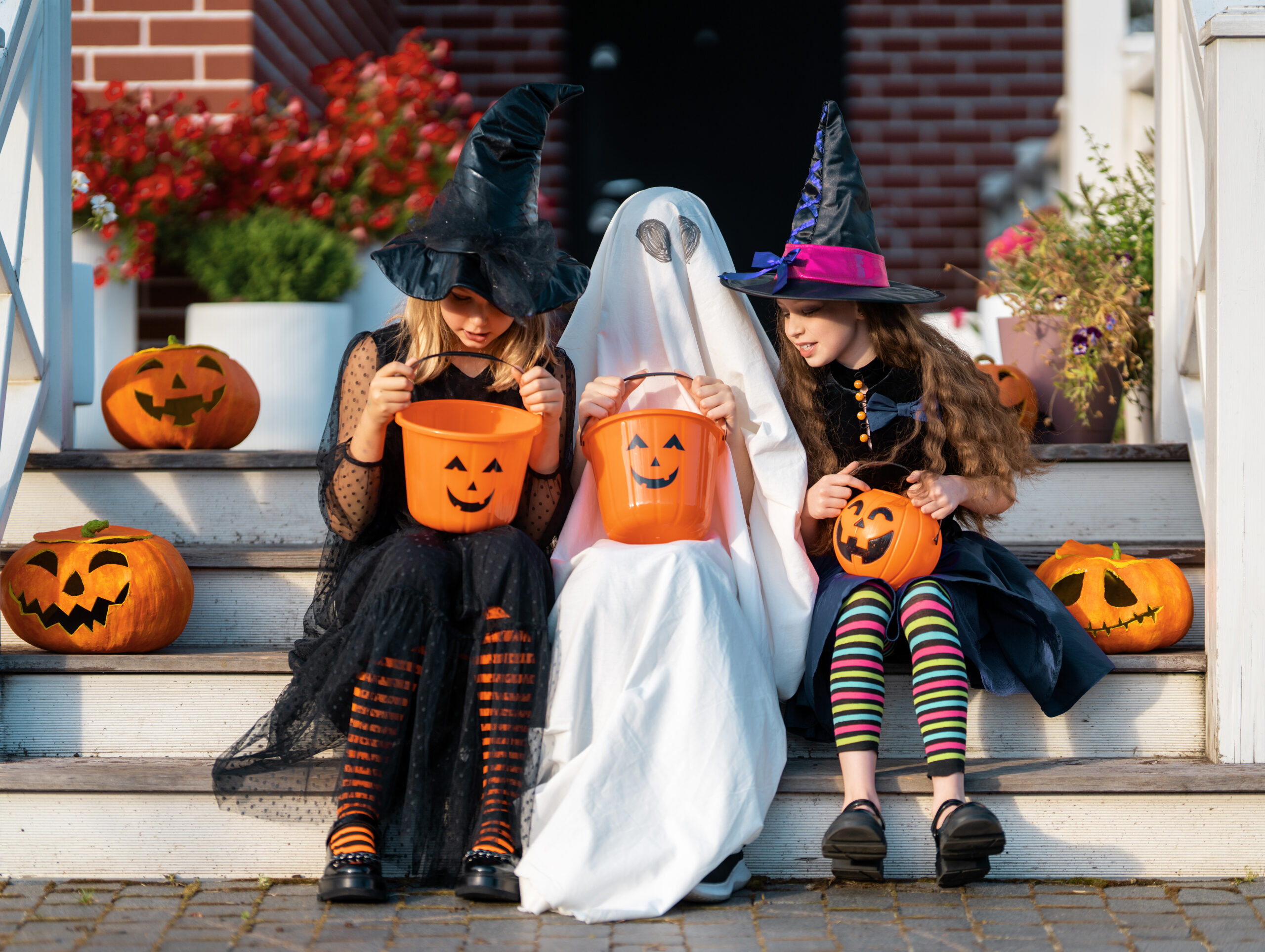 Children celebrating Halloween in Franklin, TN, trick or treating in Halloween costumes and collecting candy.